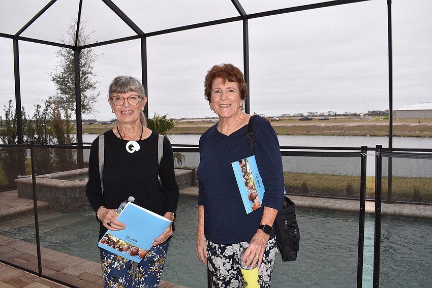 Sarasota's Beverly Wiberg and Joanne Byrne explore the pool area in one of the model homes.