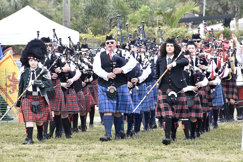 Marching bands proceed onto the field during the opening ceremony.