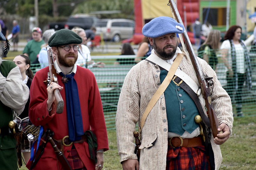 Living history performers Jacob Winge and Bryan Thagard walk in the opening ceremony.