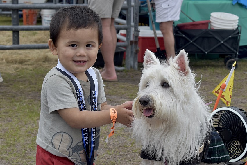 Kobe Shepherd, 1, pets Kaylee.