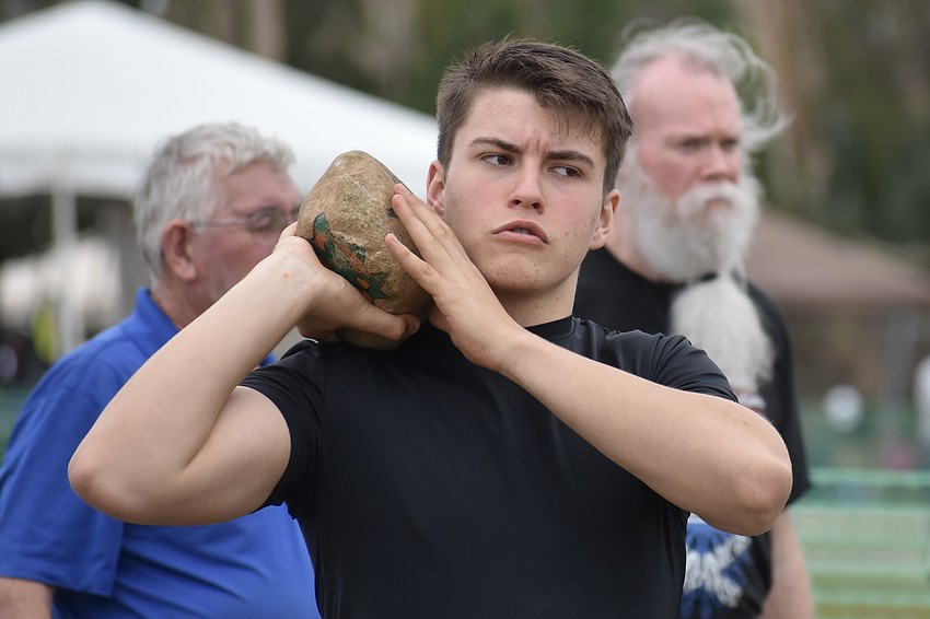 Caleb Sedlak, 16, of Bradenton, prepares for the stone put.