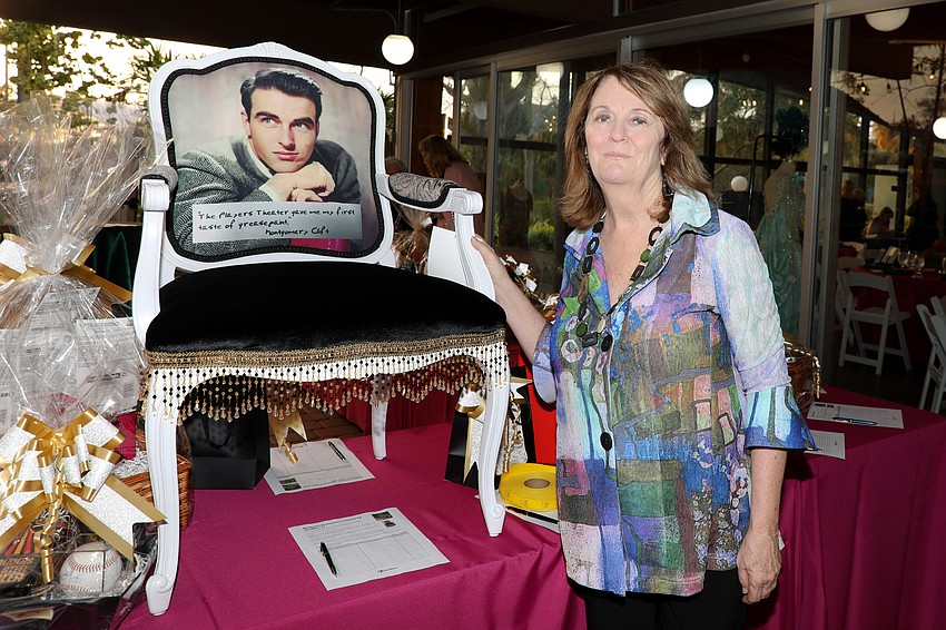 Director of Development Amy Gorman with an auction item featuring Montgomery Clift whose first stage appearance took place at The Sarasota Players Theatre in 1947.