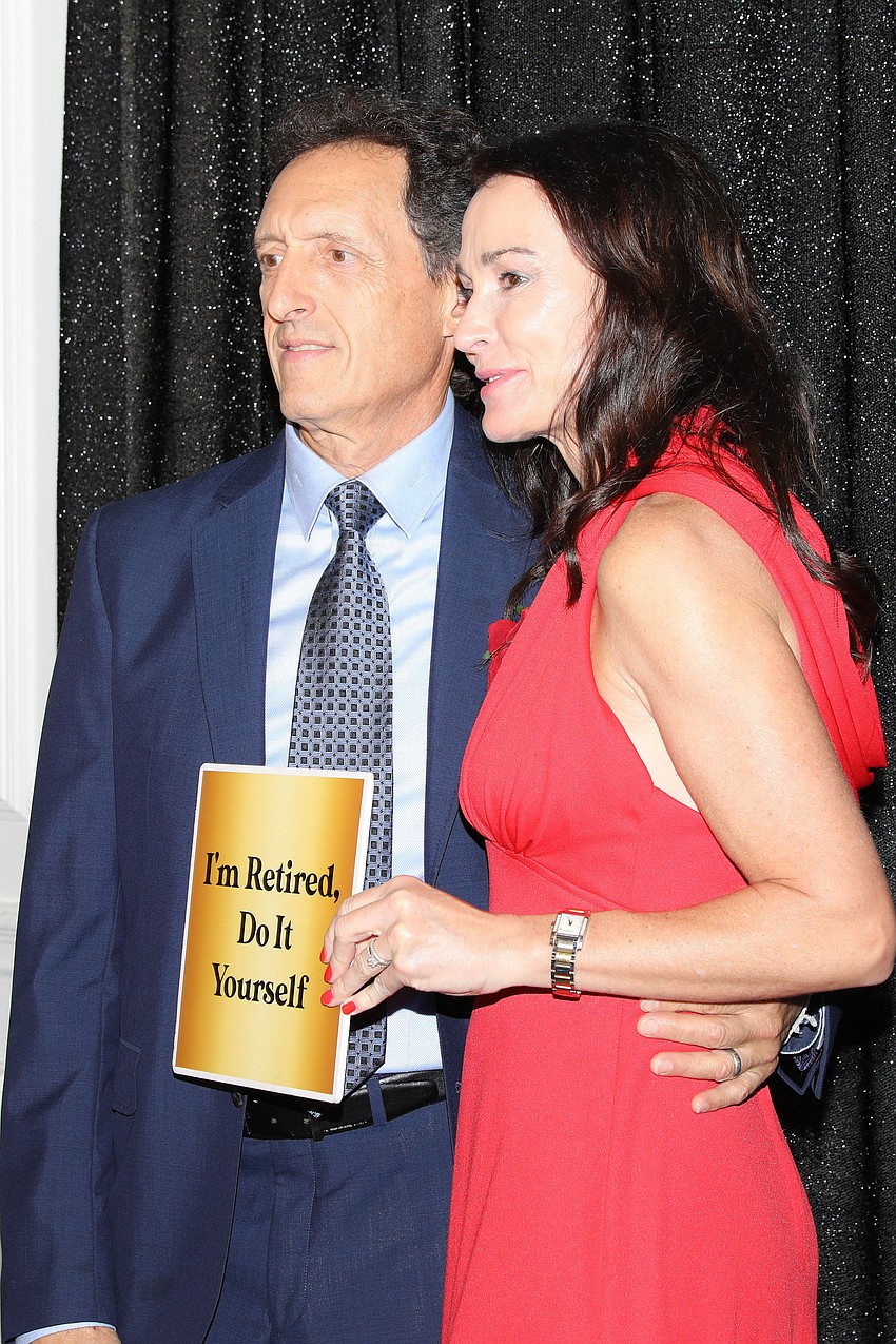 Mark Sarubbi and Christi Shaw enjoy a photo booth opportunity.