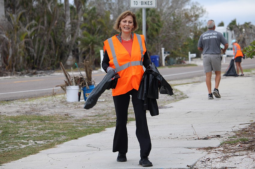 Jodene Moneuse grabs extra trash bags.