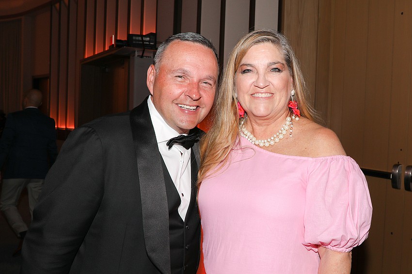 Emcee and Auctioneer Christopher Marchand with Catholic Charities Director of Communications Kirsten Pedersen