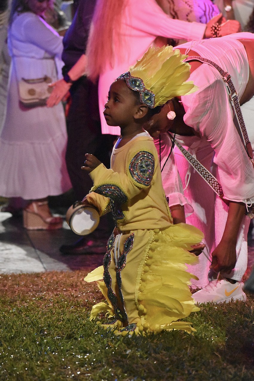 Romeo Bougere III dances to the music of The 79rs Gang, which features his father Romeo Bougere, in the courtyard.