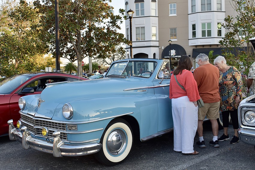 This baby blue Chrysler Windsor attracts a steady crowd at the car show.
