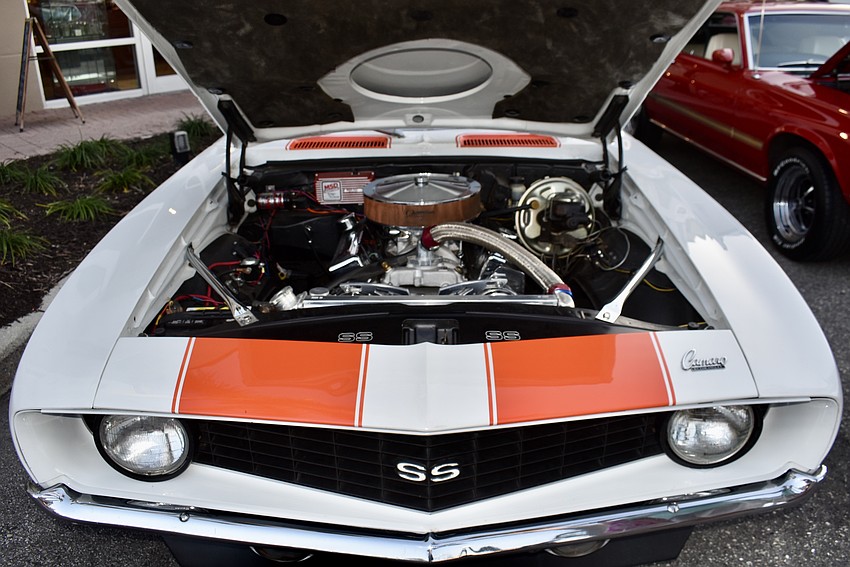 Hoods up for the car show. This is the engine of a 1969 Chevrolet Camaro.