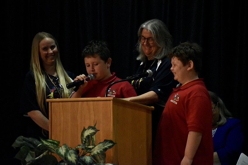 Taacher Tessa Healy, fifth grader Zayn Fielding, teacher Michelle Scotese and first grader Zeke Fielding take to the stage.