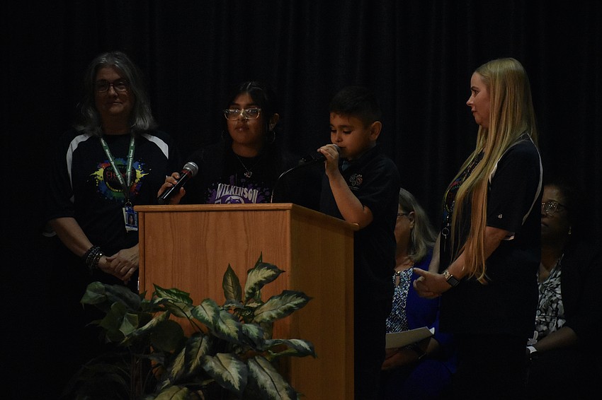 Teacher Michelle Scotese, fifth grader Abigail Munoz-Briones, second grader David Munoz-Briones, and teacher Tessa Healy take to the stage. 