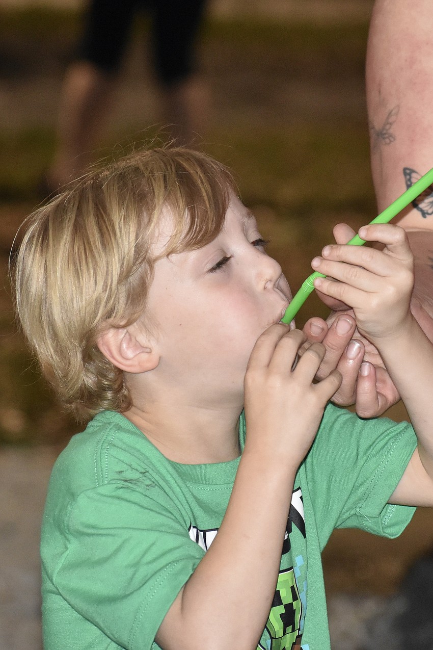Kindergartener Elijah Cleveland launches a rocket from a straw.