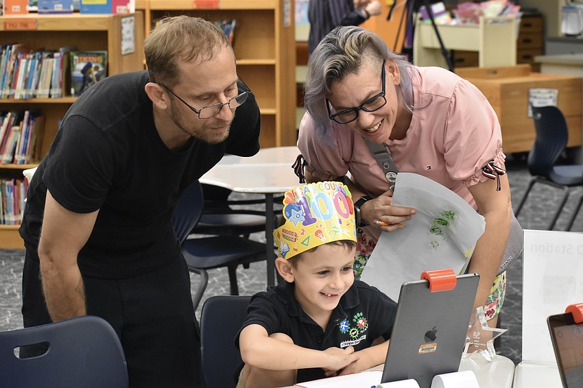 Aaron and Caroline Rickerson watch as their son, Kindergartener Troup Rickerson, plays an educational game.