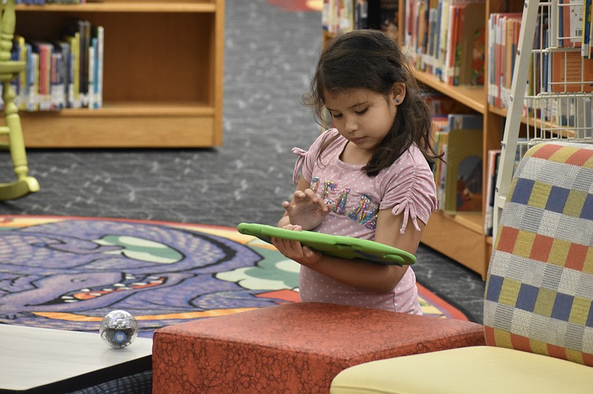 First grader Sovereign Osceola plays with a remote-controlled sphere.