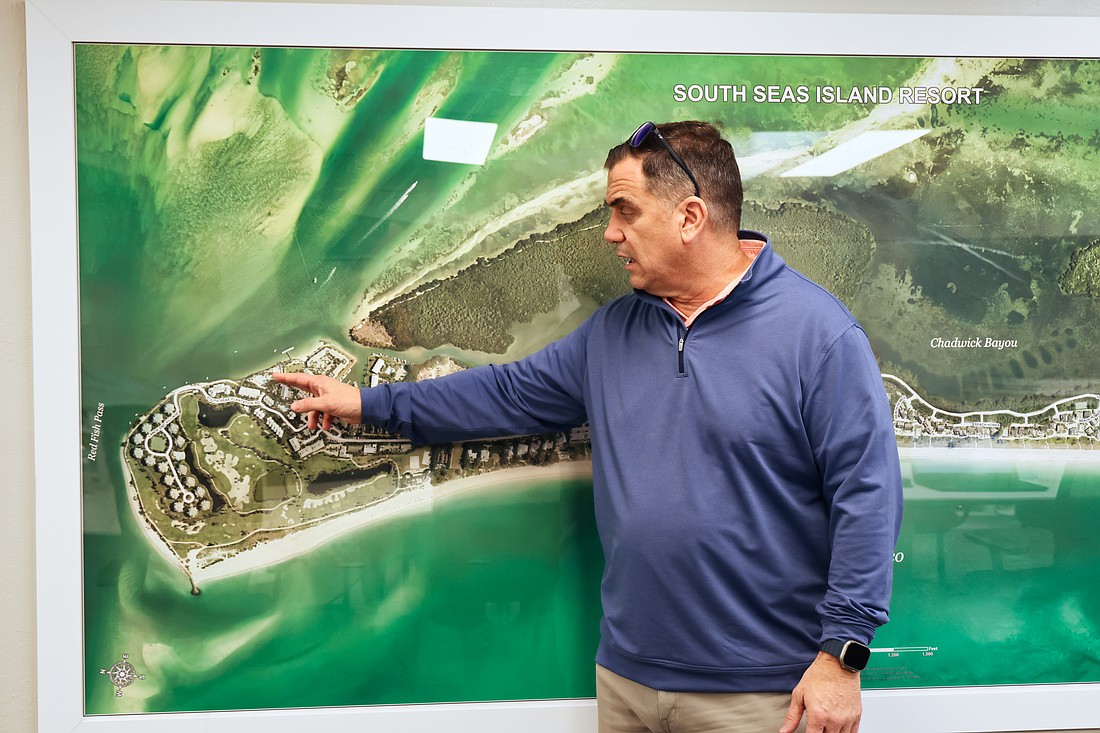 Greg Spencer, CEO of Timbers Co., shows off the plans for the South Seas resort on Captiva at the company's development site across from the main gate to the resort.