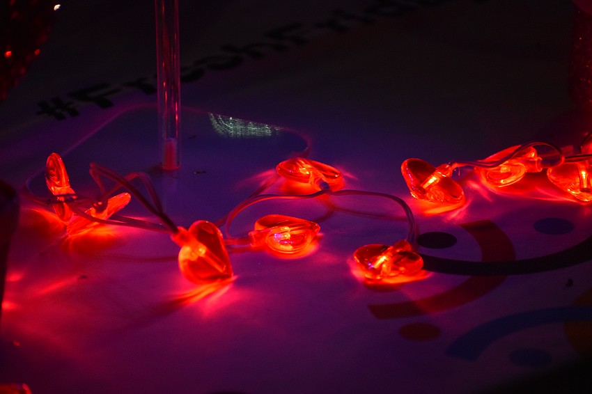 A strand of heart-shaped lights adorns a table at the event.