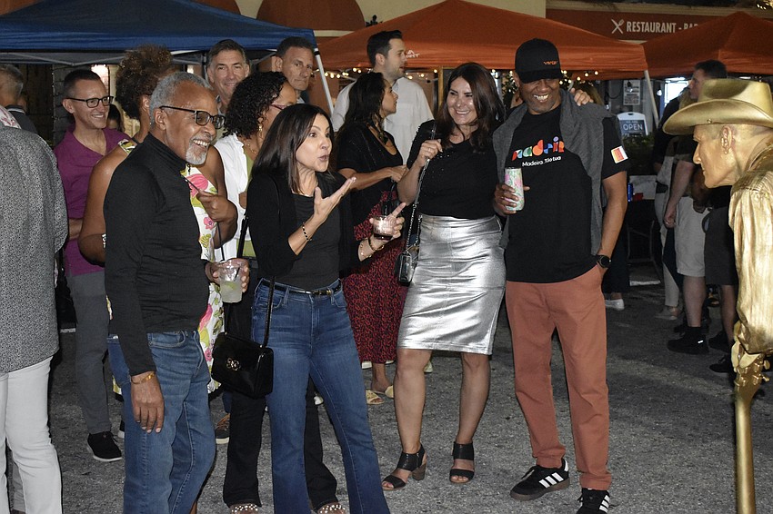 Moses Cummings, Lucy Esposito, and Monika and Arthur White encounter living statue performer Joe Abel.