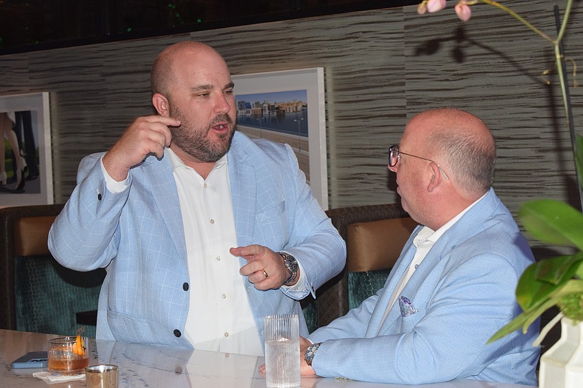 Kevin Hettinger and Patrick English converse at the bar before a soft opening event at Fleming's Prime Steakhouse and Wine Bar at UTC Saturday.