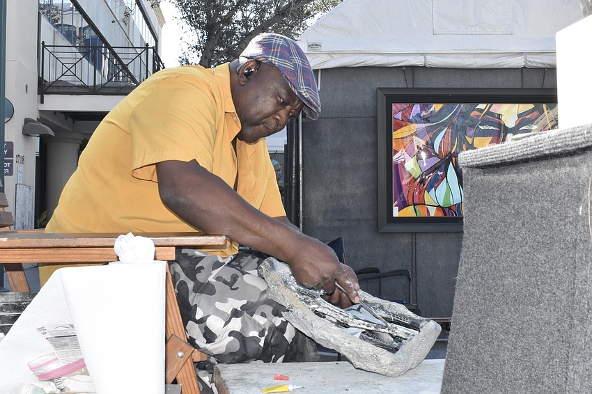 Indiana-based artist Peter Rujawa carves one of his stone sculptures, a traditional art form that comes from his Shona tribe in Zimbabwe.
