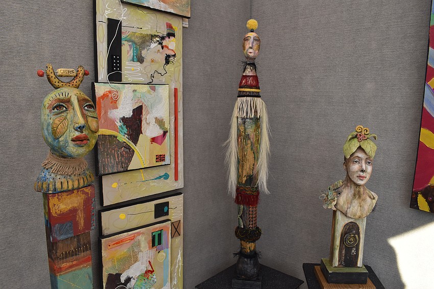 Masks by Sarasota artist Su Griggs Allen are displayed in her tent.