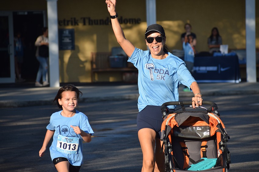 Theresa Pelayo celebrates crossing the finish line alongside her daughter, Luna Pelayo, on Saturday morning at the Taste of ODA 5K.