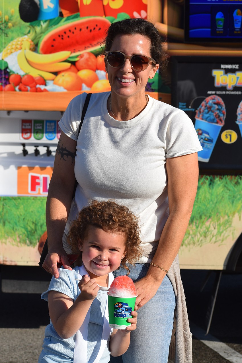 Kaya Yinling gets ready to dig into her shaved ice at the Taste of ODA 5K with her mother, Caroline Yingling, on Saturday morning.