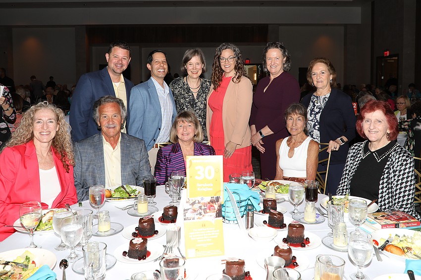 Sponsors receive table photos with award winning author Ann Patchett (standing 3rd from L).