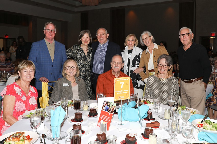 Sponsors receive table photos with award winning author Ann Patchett (standing, 2nd from L).