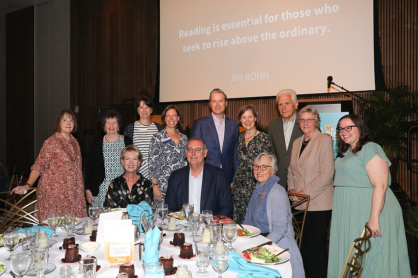 Sponsors receive table photos with award winning author Ann Patchett (standing, 6th from L).
