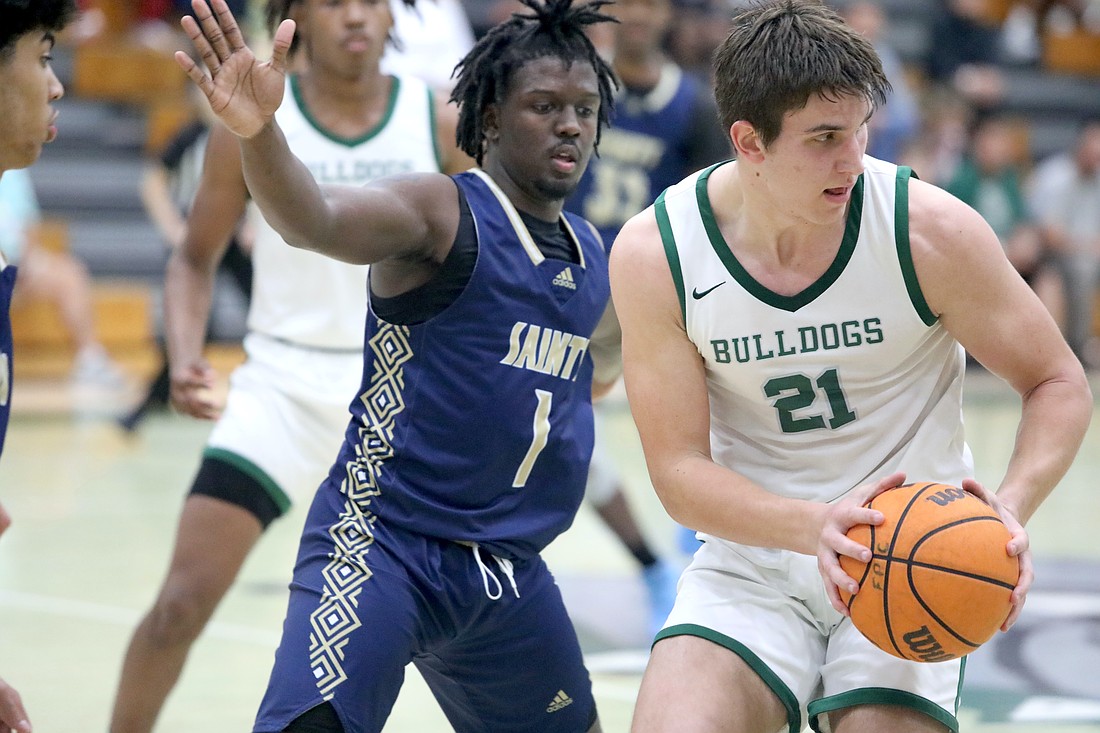 FPC's Roman Caliendo (21) is guarded by Sandalwood's Anthony Evans. Photo by Brent Woronoff