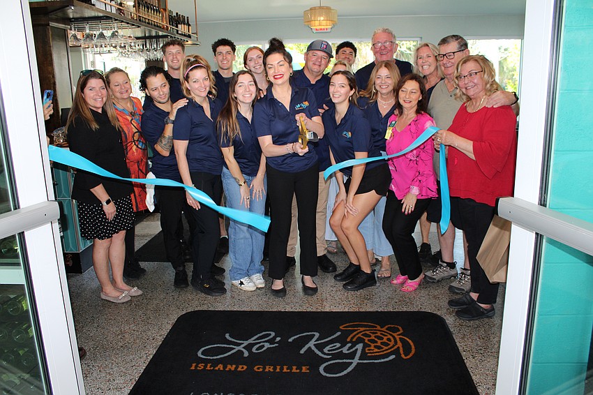 Attendees cut the ribbon for the official opening of Lo' Key Island Grille on Feb. 7.