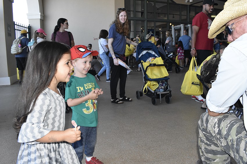 Grace Amaya, 2, Calvin Marxen, 3, and Calvin's mother Megan Murphy-Marxen meet an alligator puppet with 