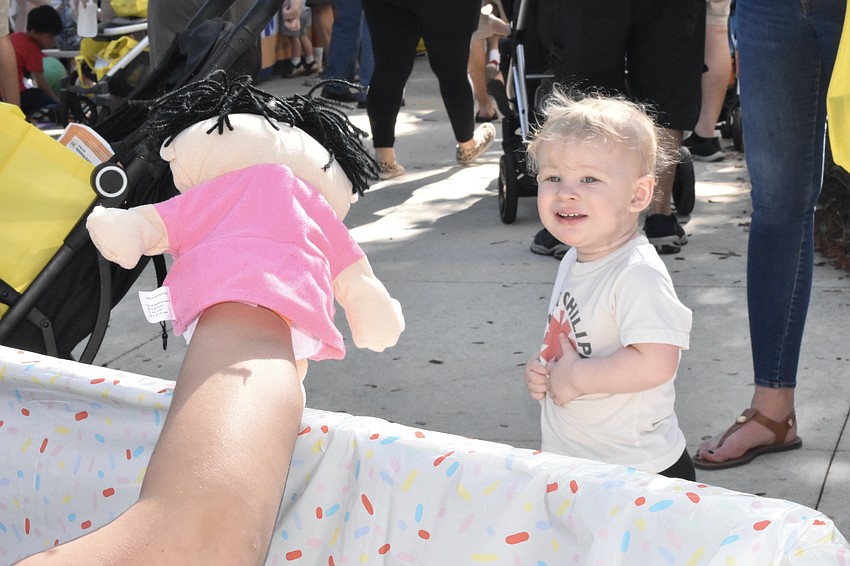 Troy Clark, 1, enjoys a puppet show by The Players Studio.