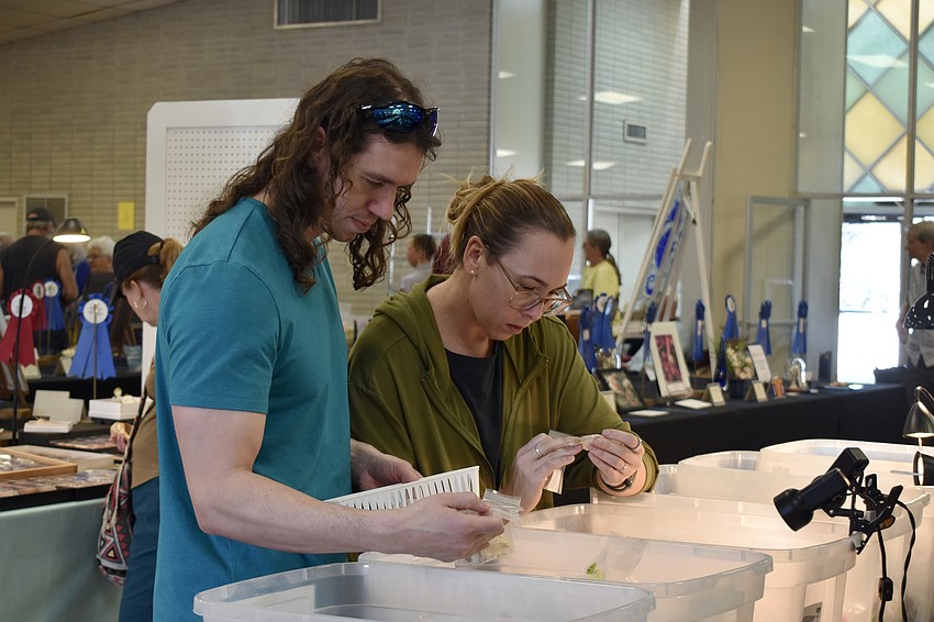 Cameron and Melissa Smith sift through containers of shells.