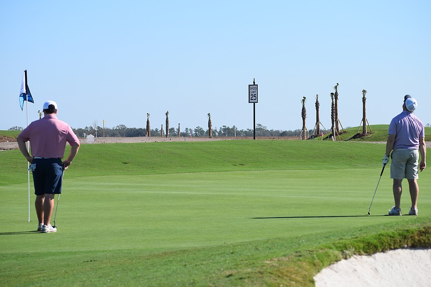 Jeremy Keller (right) throws his head back after missing a putt in the Lakewood Ranch Community Foundation's Charity Golf Scramble at Calusa Country Club.