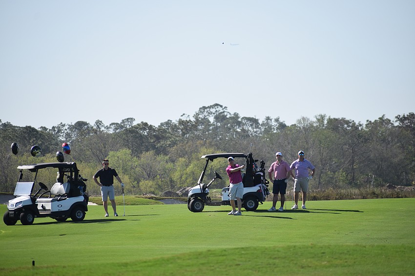 Lakewood Ranch Community Foundations President Mark Clark tries to stick his approach shot close at Calusa Country Club on Monday morning during the first-ever LWRCF charity scramble.