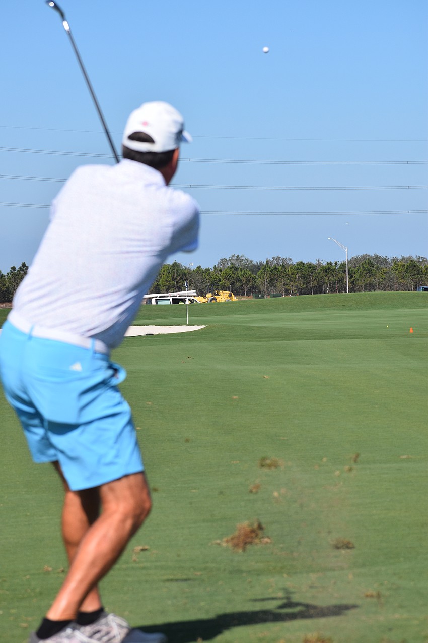 Billy Bender hits a nice approach shot that lands on the green during the Lakewood Ranch Community Foundation's Charity Golf Scramble at Calusa Country Club.
