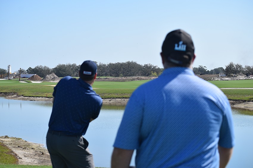 Steve Horn keeps an eye on Dennis Murphy's tee shot during the first Lakewood Ranch Community Foundation Charity Golf Scramble at Calusa Country Club.