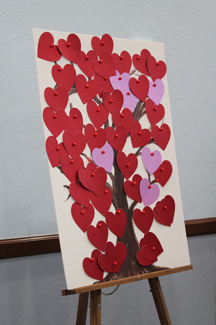 Art show attendees added to a heart tree of prayer intentions.