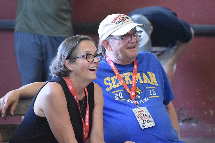Cindy and Frank Moyer watch a wrestling match.