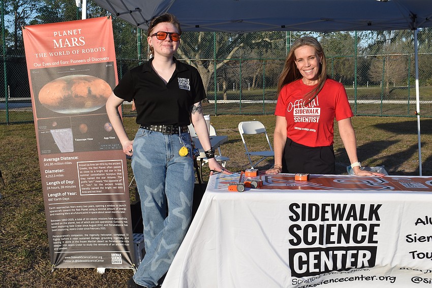 Kaya Lewis and Jennifer Arsenault are manning the Sidewalk Science Center tent.