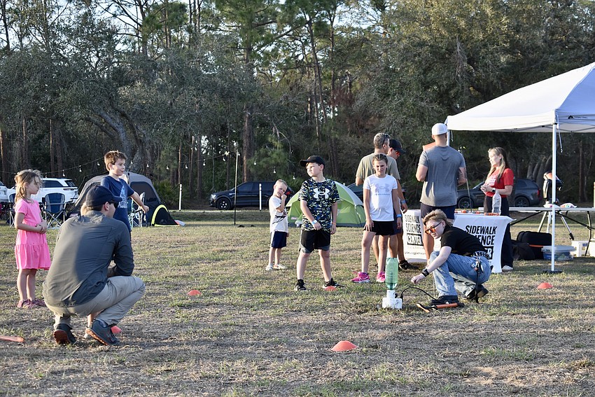 Kaya Lewis with the Sidewalk Science Center prepares to launch a bottle rocket.