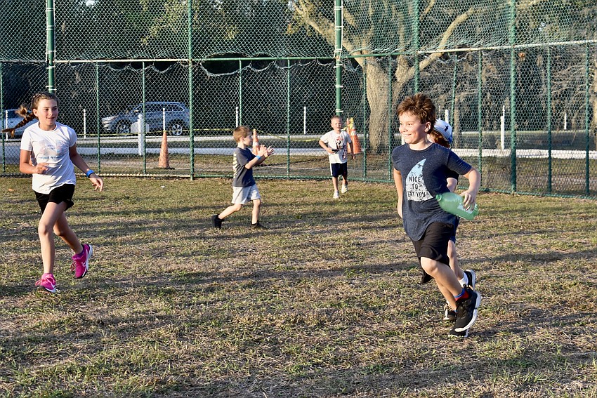 Samuel Piercy retrieves the bottle rocket after the launch at the Lakewood Ranch Community Campout.