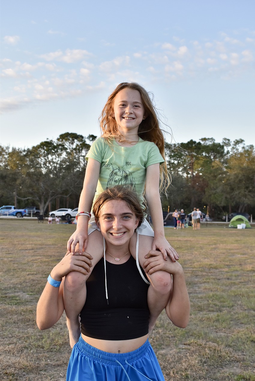 Claire Pies sits on her neighbor Parker Thiemann's shoulders during the Lakewood Ranch Community Campout.