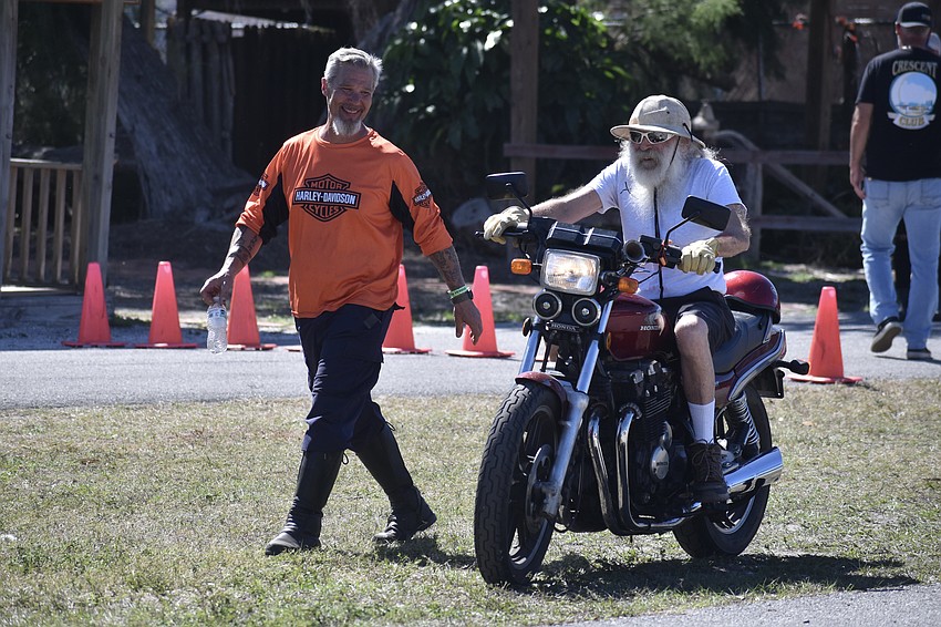 Jason McKenna, owner of Pro-Rider 603 in New Hampshire, talks with Doc Fox, a longtime Sarasota resident, after he completes a round of the slow race.