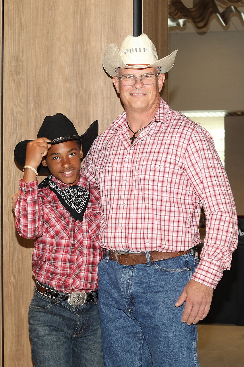 Four months ago Jon Allen (R) became a Big Brother to Carlton McCullough. They shopped in Arcadia for their Western Wear.