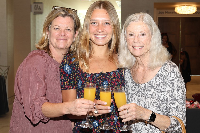 Christy Andacht, Maddie Andacht and Connie Rounds toast to Big Brothers Big Sisters.
