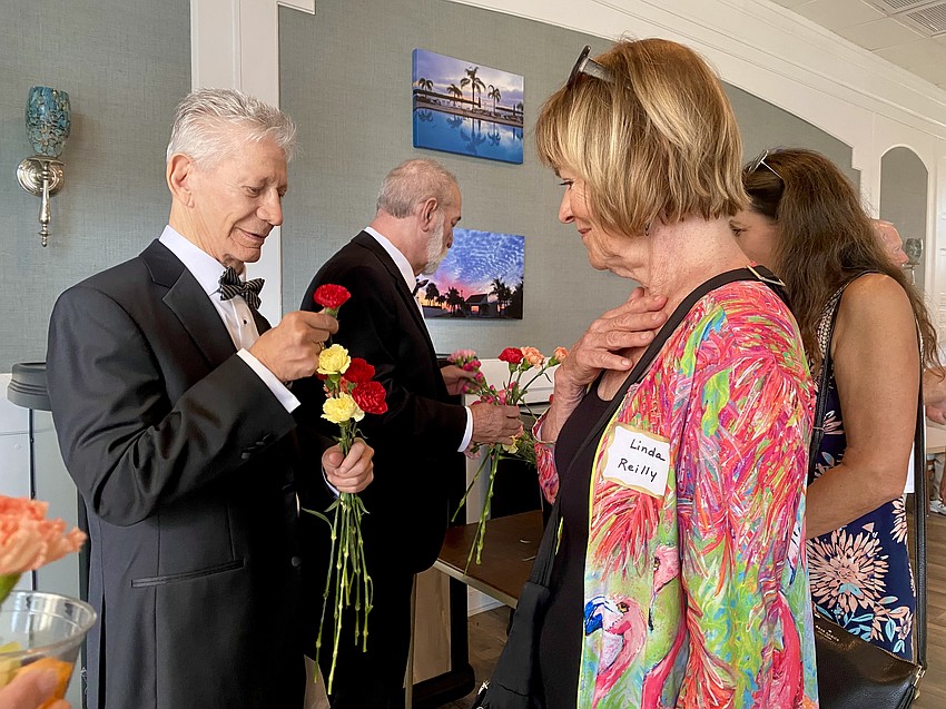 Stewart Sinai presents Linda Reilly with a parting carnation.