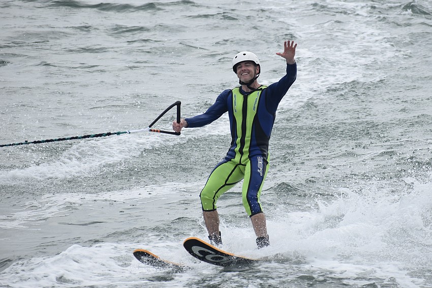 Lance Robbins waves to the crowds as he passes by.