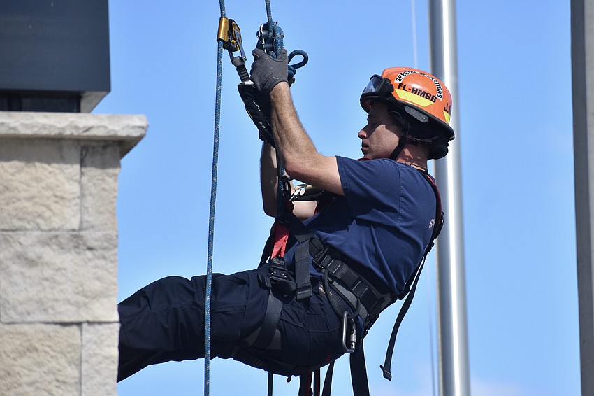 Firefighter/EMT Josh Gilliam performs a rapelling demonstration.