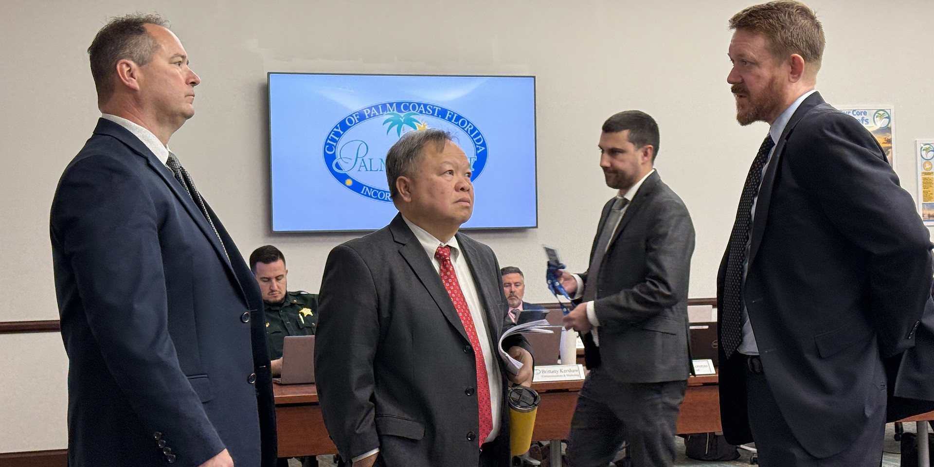 City staff members Ray Tyner and Phong Nguyen discuss a new development planned on State Road 100, with the developer's representative, Jay Livingston. Photo by Brian McMillan